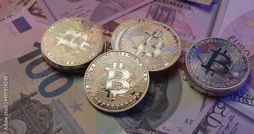 Gold Bitcoin on Euro and Dollar banknotes. Different currencies with Cryptocurrency BTC. Blockchain technology used for financial transactions