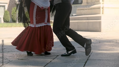 Traditional chotis dance performed  by chulapos in Madrid. Chotis is a traditional and popular dance that is performed in Madrid castizo during verbenas and Fiesta de San Isidro. Close up footage.  photo