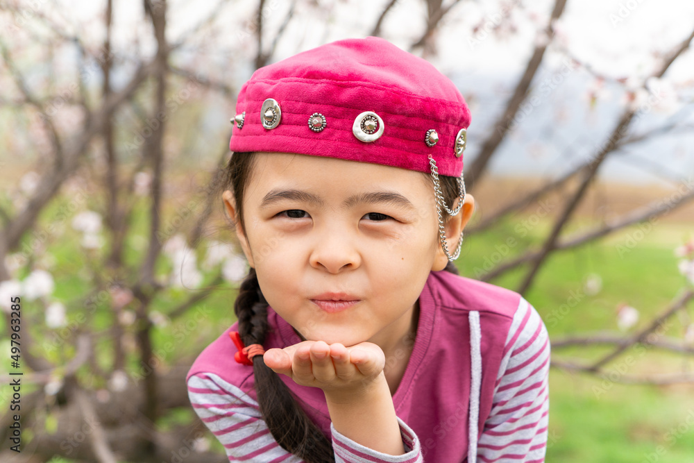 girl in a national headdress. Spring, Nowruz holiday. Kazakh girl. Central Asia, Kazakhstan. girl in a national headdress. Spring, Nowruz holiday. Kazakh girl. Central Asia, Kazakhstan.