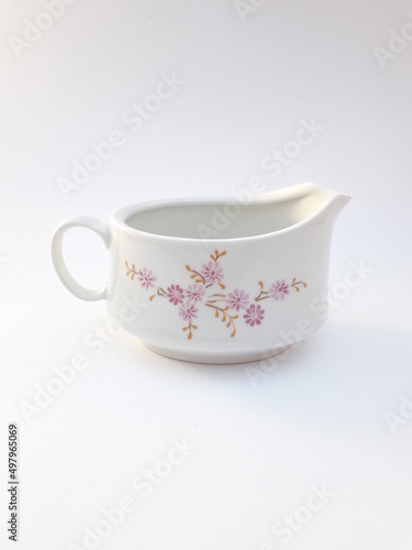 Vintage porcelain saucer, pitcher with pink flower pattern, isolated