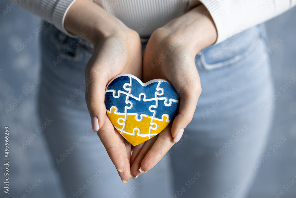A heartshaped badge depicting the State Flag of Ukraine as a symbol of