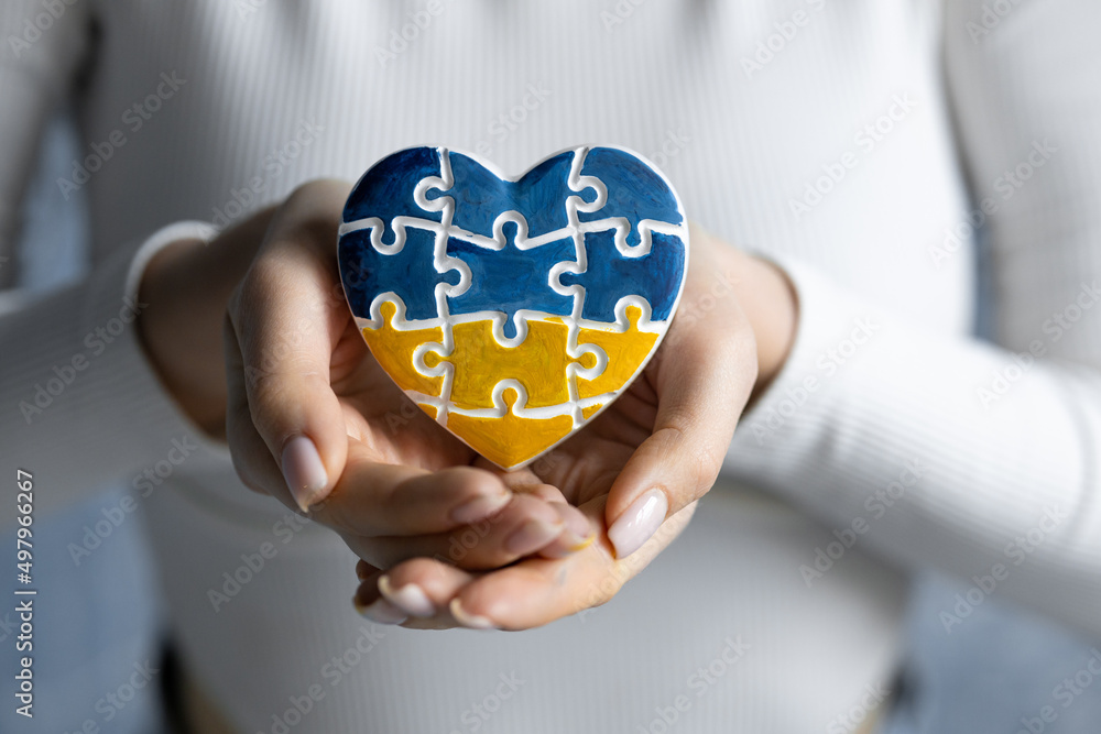A heartshaped badge depicting the State Flag of Ukraine as a symbol of