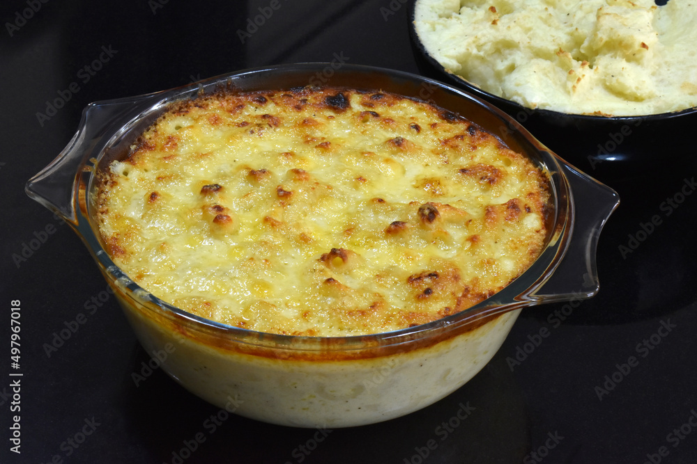 Baked macaroni and cheese in a glass bowl. Baked macaroni and cheese in a glass bowl.