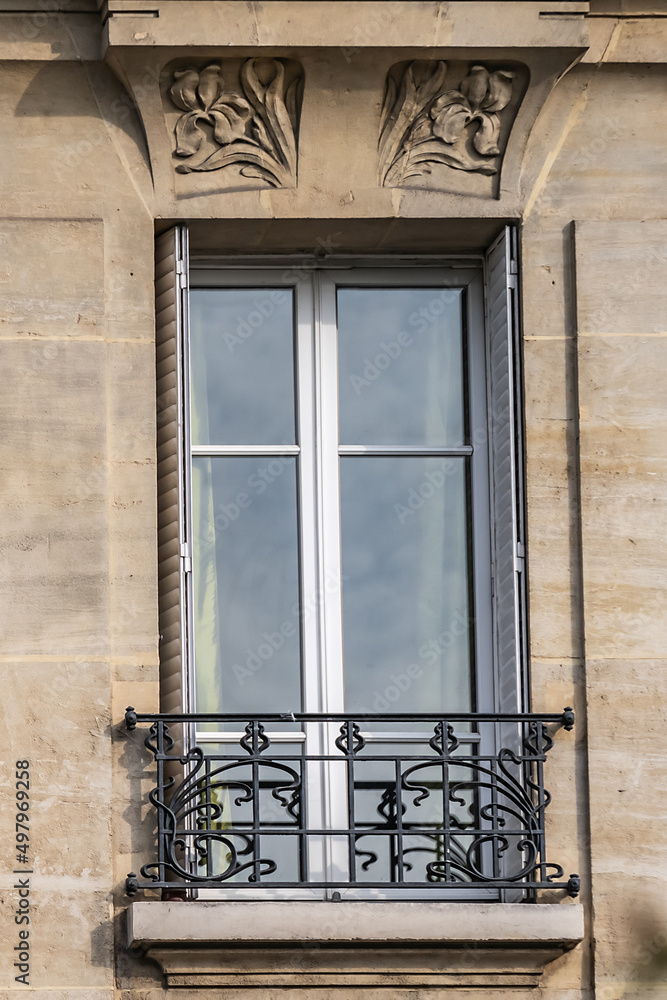 Obraz premium Traditional French house: balconies and windows. Paris, France.