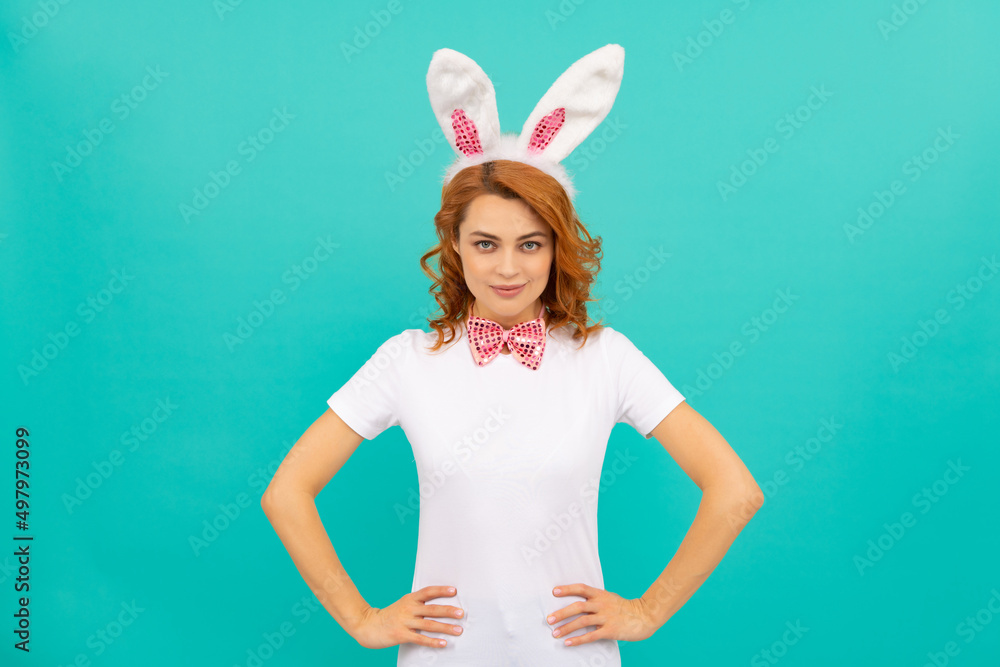 smiling easter woman in bunny ears and bow tie on blue background smiling easter woman in bunny ears and bow tie on blue background