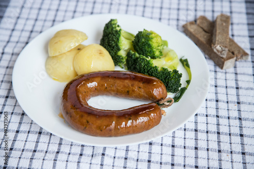 Alheira, a typical dish of Portuguese gastronomy made of pork accompanied by broccoli and boiled potatoes drizzled in olive oil. Typical meal and much appreciated in the coldest season of the year. photo