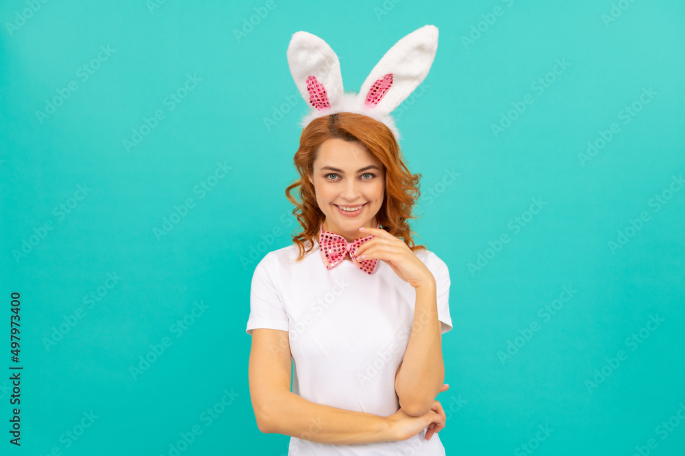 happy glad easter woman in bunny ears and bow tie on blue background