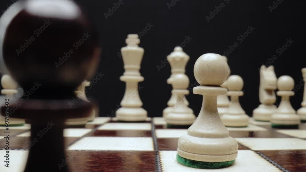 Chess close-up macro. The white pawn wins and takes the black pawn. Chess close-up macro. The white pawn wins and takes the black pawn.
