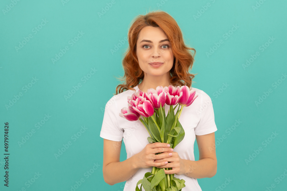 positive woman with tulip flower bouquet on blue background positive woman with tulip flower bouquet on blue background