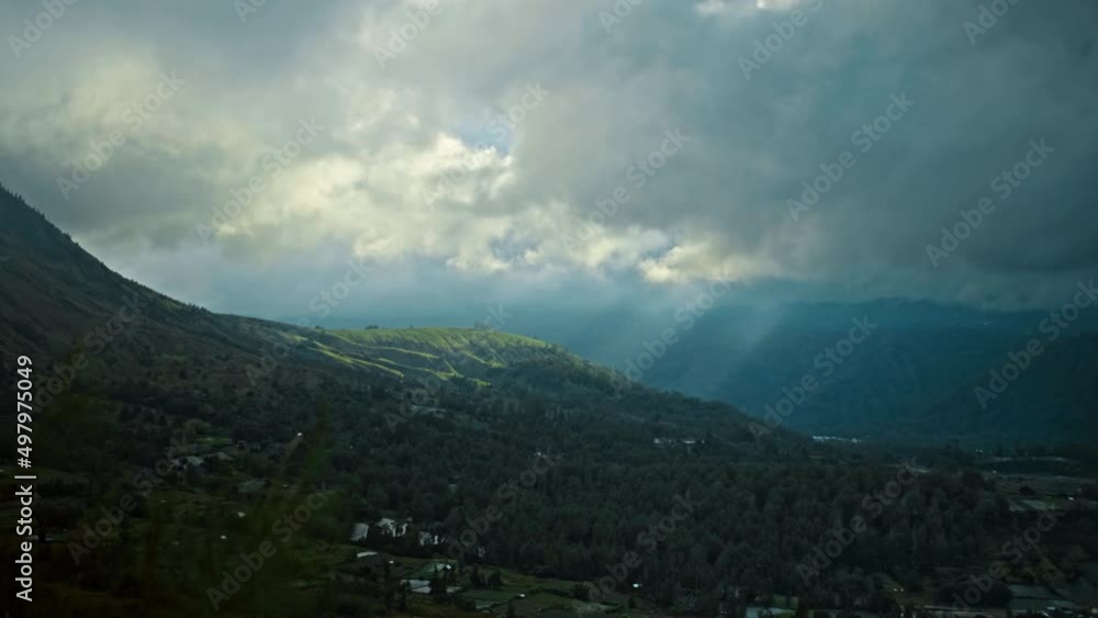 View of the green mountain from the far covered with a clouds View of the green mountain from the far covered with a clouds