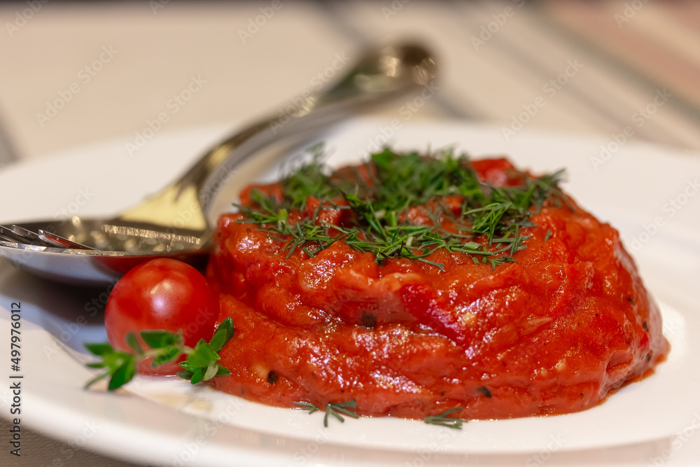 Sauce of baked tomatoes and red pepper on a plate
