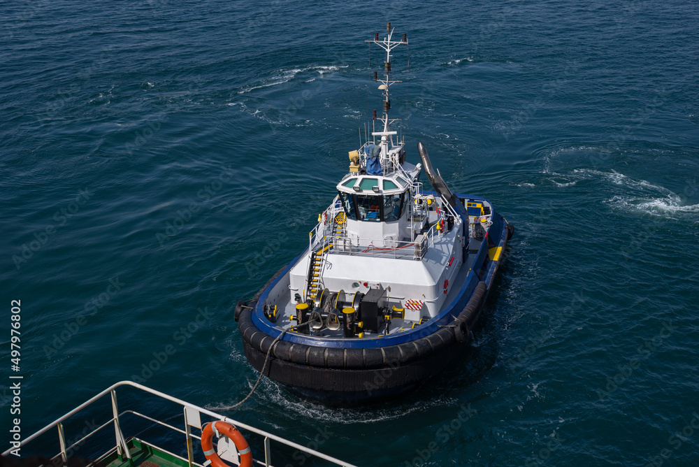 Naklejka premium Tugboat during mooring operation at sea