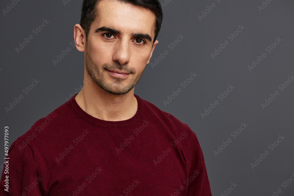 Obraz premium portrait man in a red sweater hand gesture posing self confidence isolated background