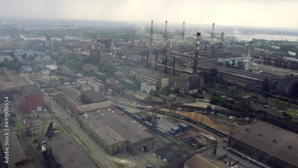 a large steel plant during the day, the copter flies from a bird's eye view over the smoking chimneys. the drone flies over the industrial plant. flights from high a large steel plant during the day, the copter flies from a bird's eye view over the smoking chimneys. the drone flies over the industrial plant. flights from high