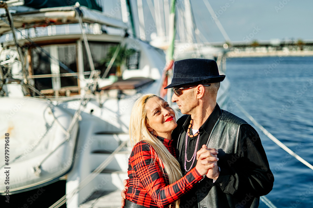 Romantic middle-aged couple embracing at the port