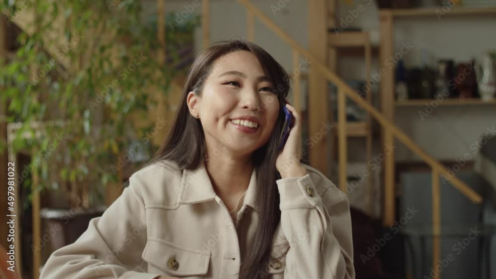 A beautiful woman is smiling while talking on the phone A beautiful woman is smiling while talking on the phone