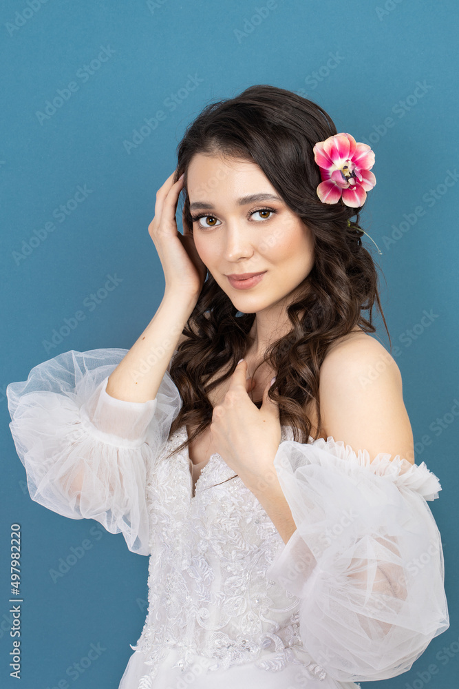 Beautiful young girl holding pink flower buds in her hands. Beautiful young girl holding pink flower buds in her hands.