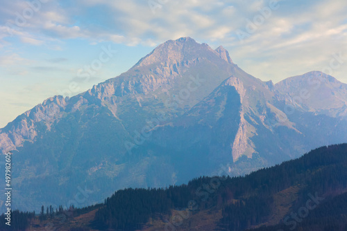 beautiful nature background of High Tatra ridge. scenic landscape view in evening light. clouds on the sky above the peaks. outdoor adventure concept