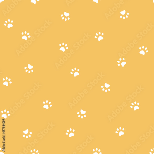 Seamless vector pattern with cat or dos paws prints on yellow background.