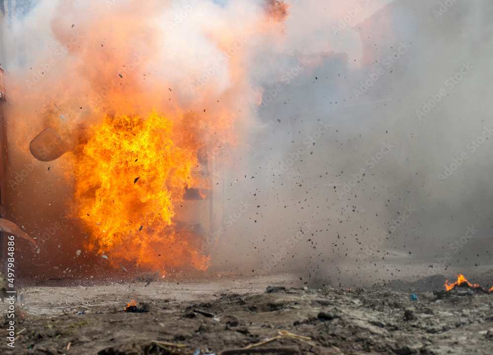 real explosion with fire smoke and dust in the street without people