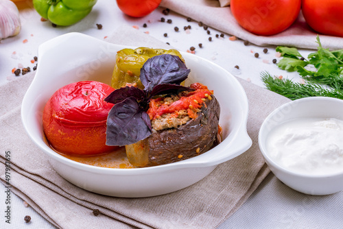 dolma in azerbaijani, meat in grilled vegetables on a white plate photo
