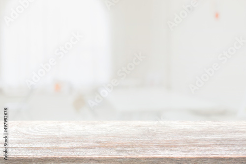 Empty wood table top and blurred coffee shop, cafe and restaurant interior background - can used for display or montage your products.