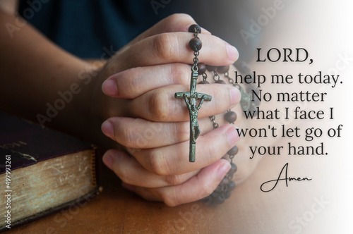 Christian prayer seeking help from God with women hand holding Holy Rosary background. Religious concept