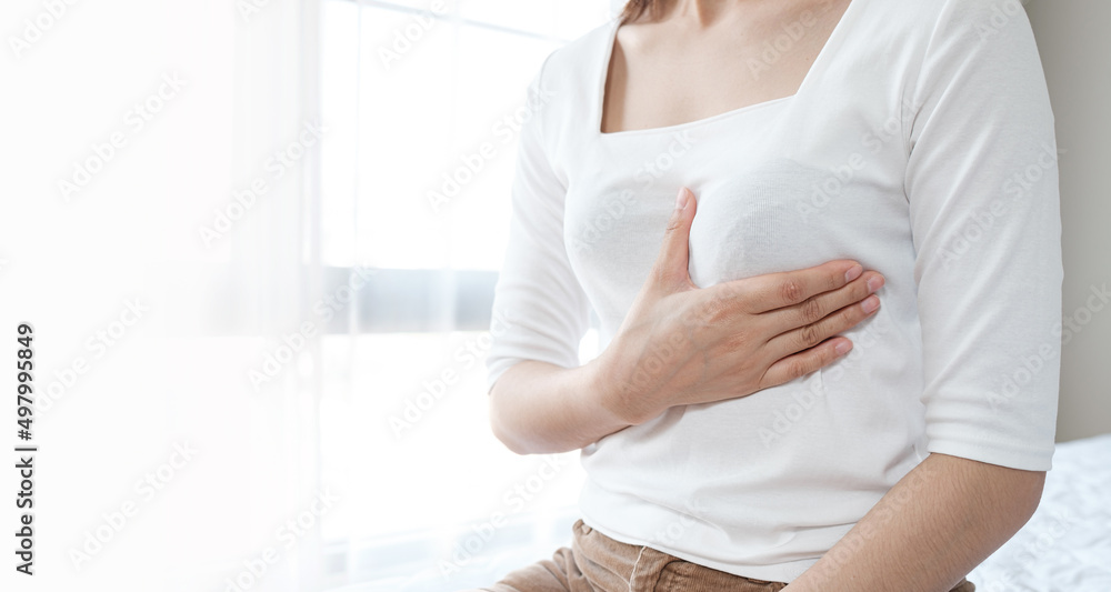 Woman hands touching her breast. Breast cancer self check. Healthcare and medical concept Woman hands touching her breast. Breast cancer self check. Healthcare and medical concept