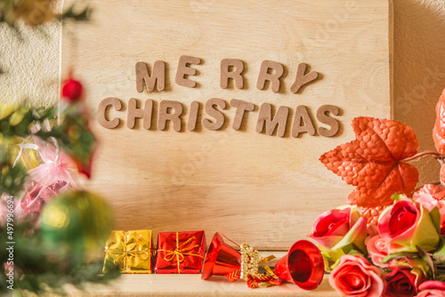 Text the word Christmas decorated with beautiful flowers and more.