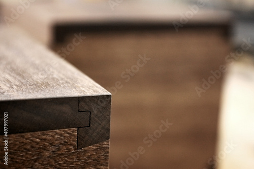 Closeup of wood joinery detail of a box, with blurred background