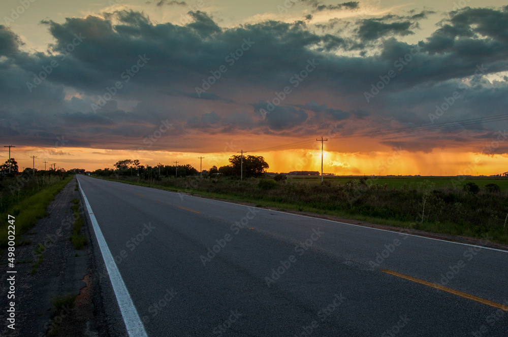 Fototapeta premium sunset on the road in santa vitória do palmar