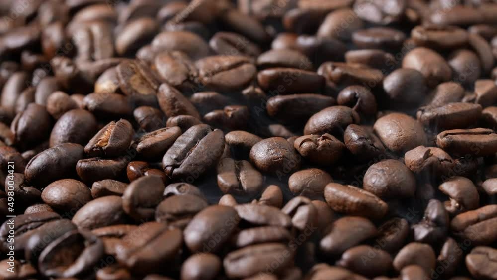 Rotation of pile roasted coffee beans. Freshly roasted strong aromatic coffee beans in a large pile. Slow motion. Rotation of pile roasted coffee beans. Freshly roasted strong aromatic coffee beans in a large pile. Slow motion.