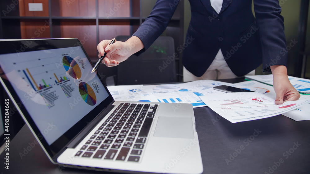 Businesswoman using computer and graph showing successful teamwork. Summary of past income and expenses, business idea Businesswoman using computer and graph showing successful teamwork. Summary of past income and expenses, business idea