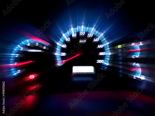 The speedometer of a modern car shows a high driving speed. Added motion blur