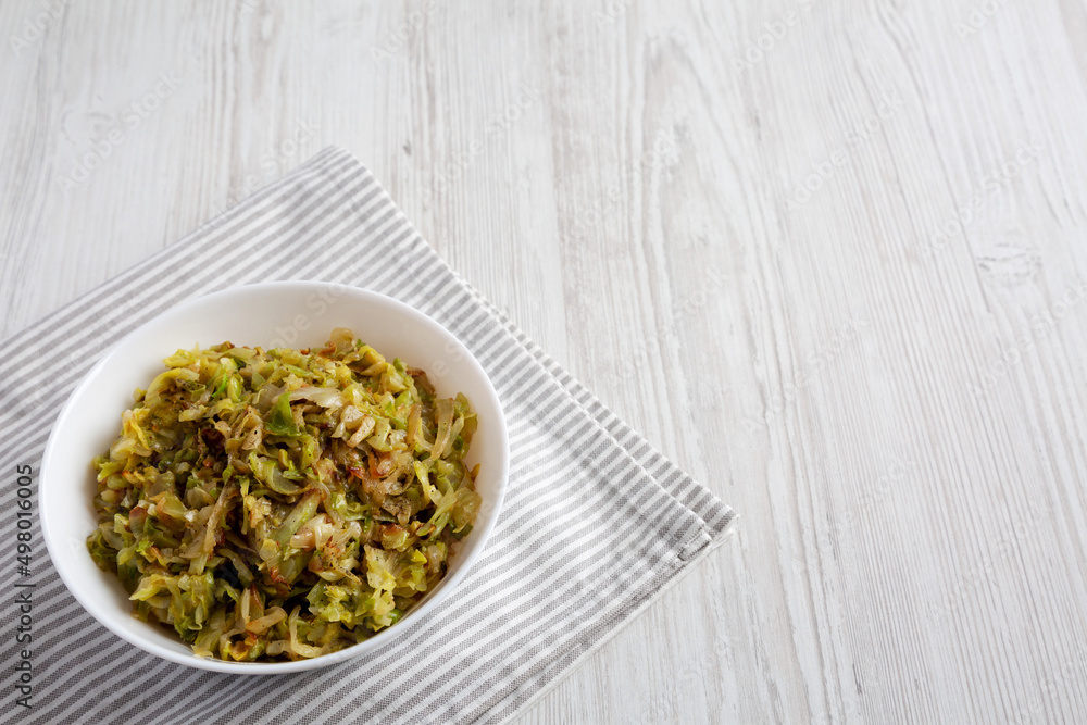 Homemade Irish Sauteed Cabbage in a Bowl, side view. Space for text.