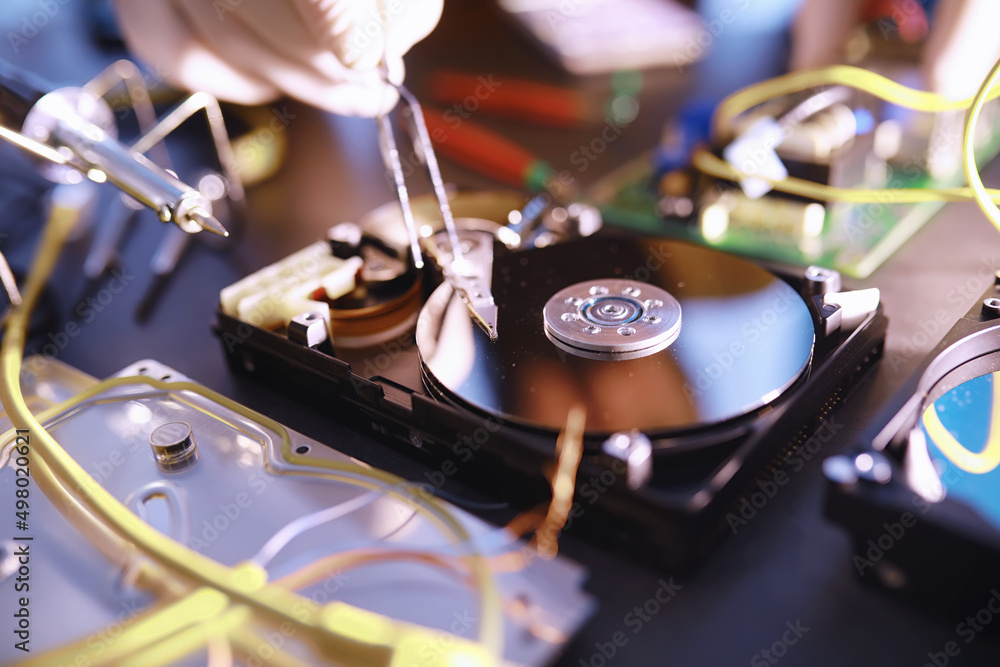 Obraz premium Computer equipment. Repair of PC components. Hard drive for restoration in the workshop. Winchester virus recovery.