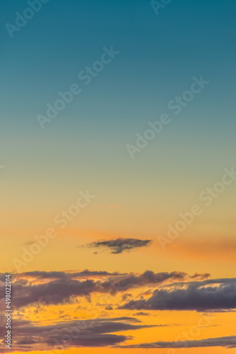 Cover page with gradient deep blue sky, illuminated clouds at bloody sunset as a background. © neurobite