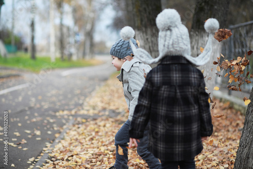 Children walk in the autumn park