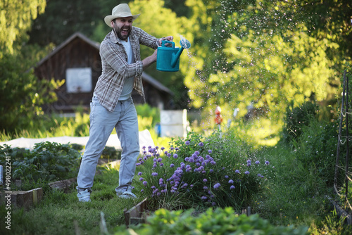 Man farmer watering a vegetable garden © alexkich