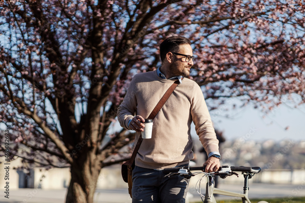 A environmentally conscious man commutes with bicycle on work. A environmentally conscious man commutes with bicycle on work.