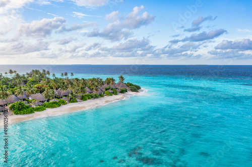 Fototapeta Naklejka Na Ścianę i Meble -  Aerial top view of pool villas, bungalows in Maldives paradise tropical beach. Amazing blue turquoise sea lagoon,  ocean bay water. Luxury travel vacation destination. Beautiful sunny aerial landscape