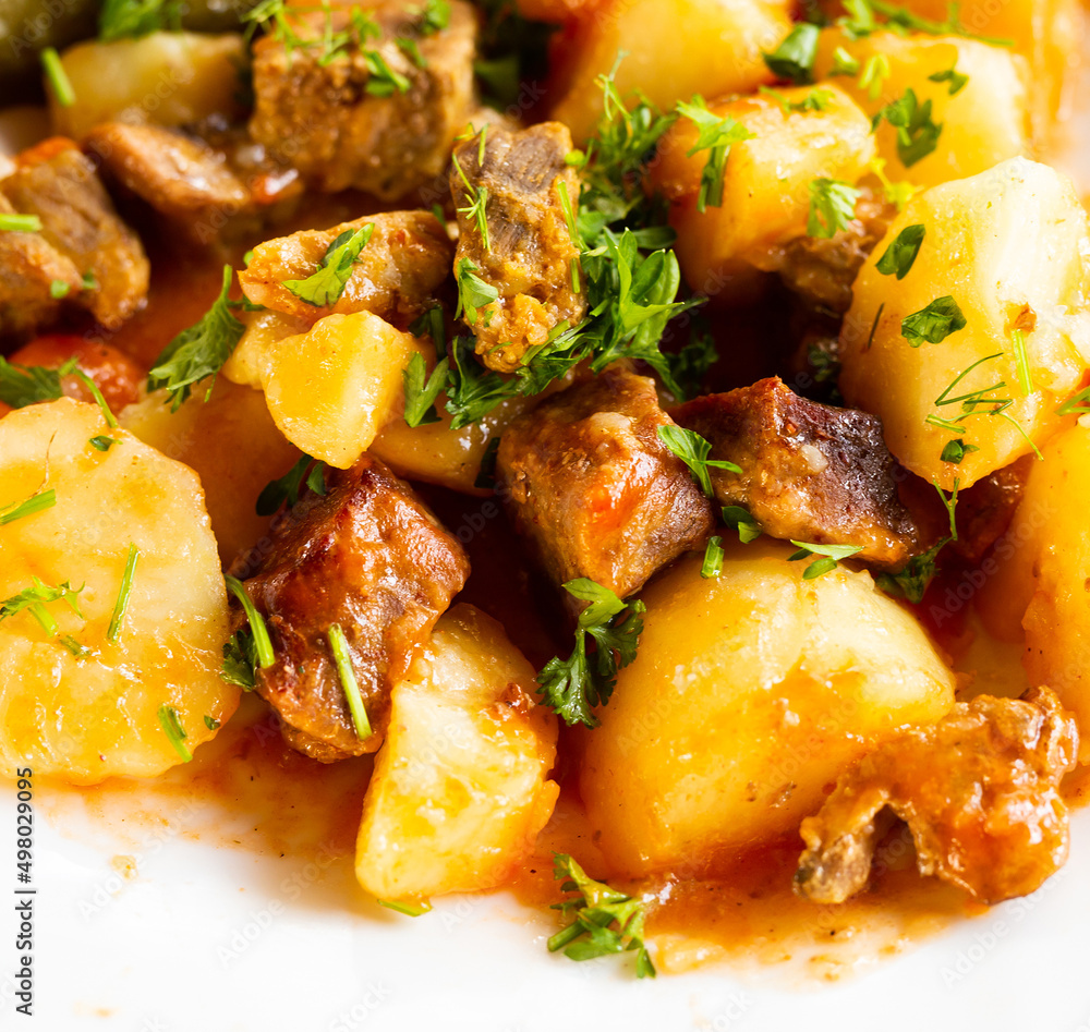 dish of baked potatoes with beef stew with herbs dish of baked potatoes with beef stew with herbs