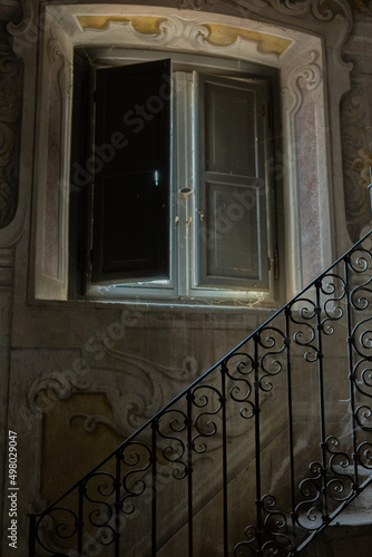 an old vintage beautiful staircase in an antique villa with railings