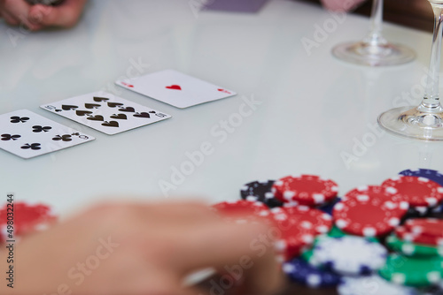 Poker game with chips, cards on the table. Enjoying the moment, digital detox with friends. Lifestyle photography. Candid moment. Selective focus.
