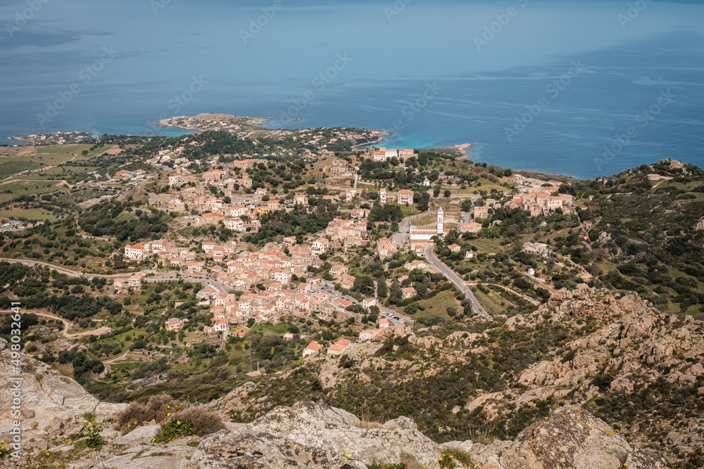 Hilltop village of Corbara in the Balagne region of Corsica with Mediterranean sea in the distance