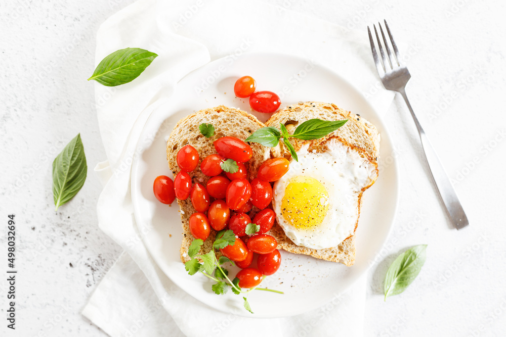 Healthy breakfast toast with fried egg and tomatoes. Healthy breakfast toast with fried egg and tomatoes.