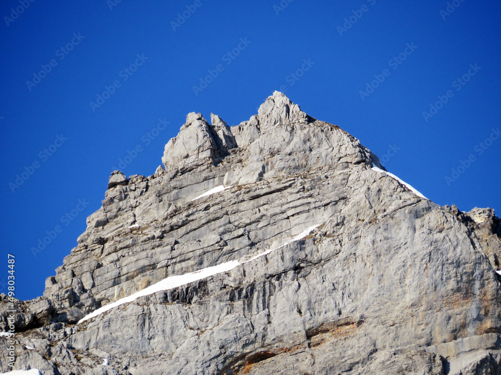 Rocky peak Rädertenstock (Raedertenstock or Redertenstock, 2294 m) in the Schwyz Prealps mountain range and over the Wägitalersee reservoir lake (Waegitalersee) - Canton of Glarus, Switzerland