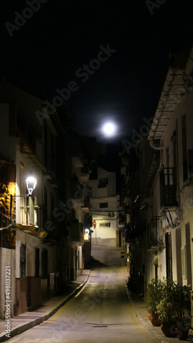 Full moon over village street