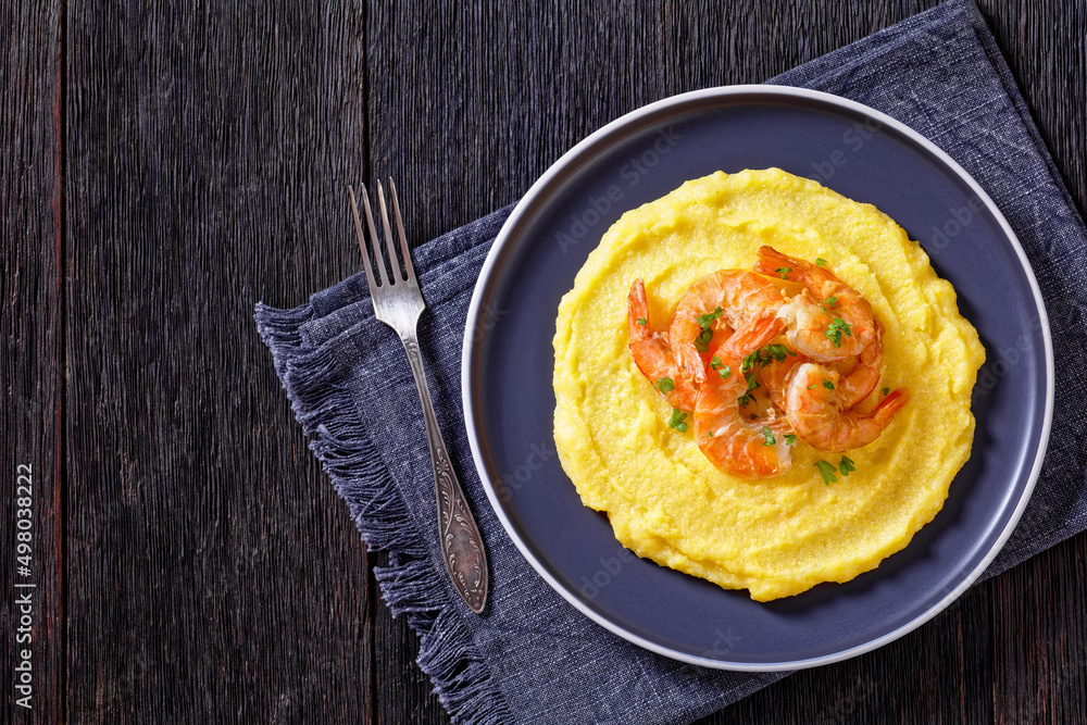 polenta with fried shrimps on plate, top view polenta with fried shrimps on plate, top view