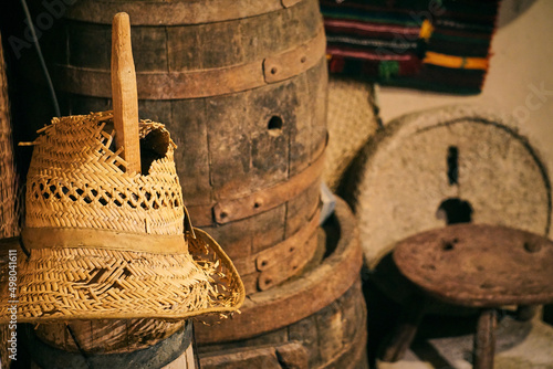 Old torn cowboy hat and wine cascs photo